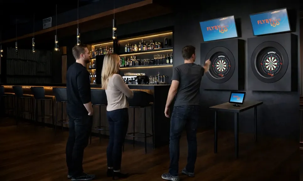 Three guests playing at bespoke FLYBY Darts oches built into a bar interior