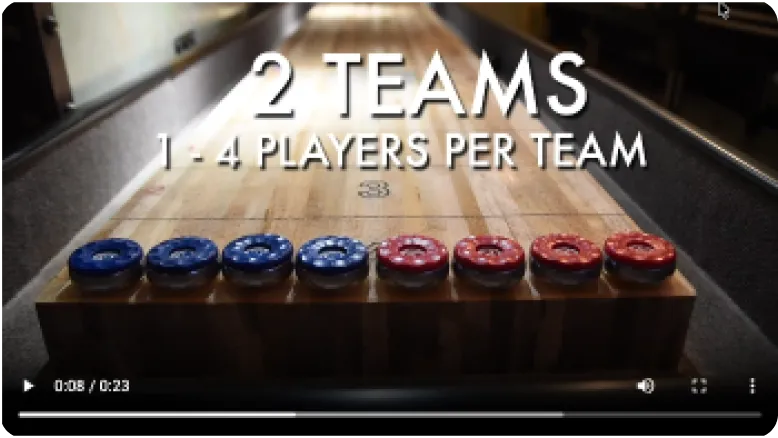 Still from the How to play SHUFL. video, showing two teams of pucks lined up on the table
