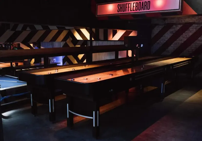 Shuffleboard tables under a neon sign at Roxy Ballroom