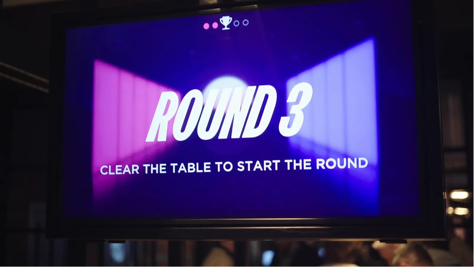 A SHUFL Tech screen above a table showing "Round 3 — clear the table to start the round"